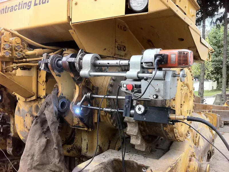 Mobile line boring machine mounted in an excavator linkage