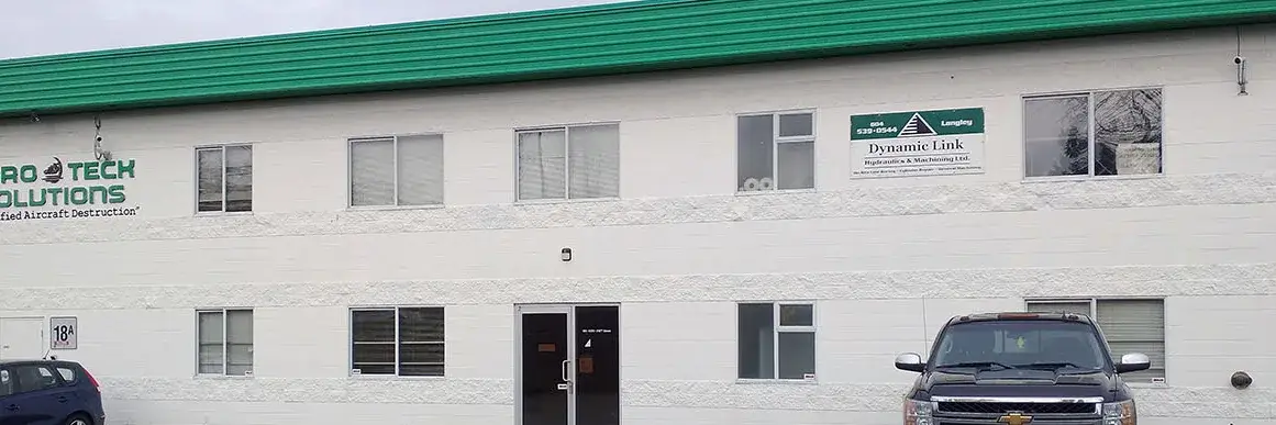 Dynamic Link Hydraulics and Machining sign on the Hangar 18A building in Langley