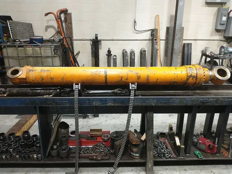 Long yellow hydraulic cylinder on the repair bench