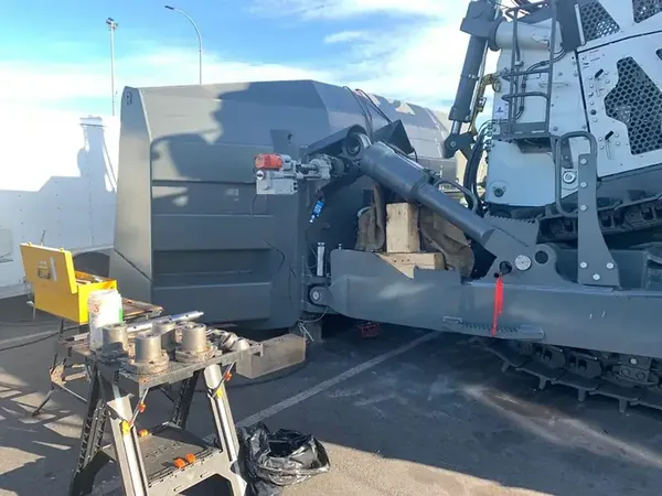 Line boring setup on an excavator boom on site