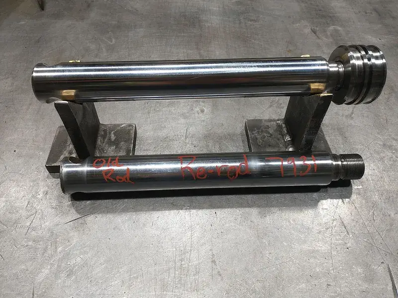 Machined steel shafts and fixture on a shop table